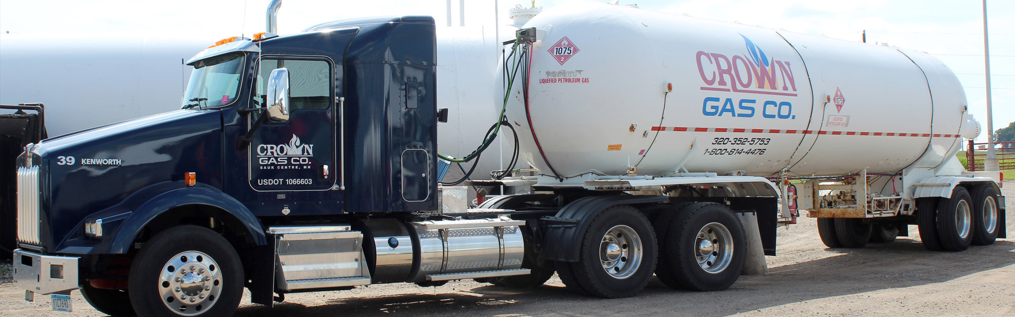 Semi-tractor pulling a large propane tank for commercial services