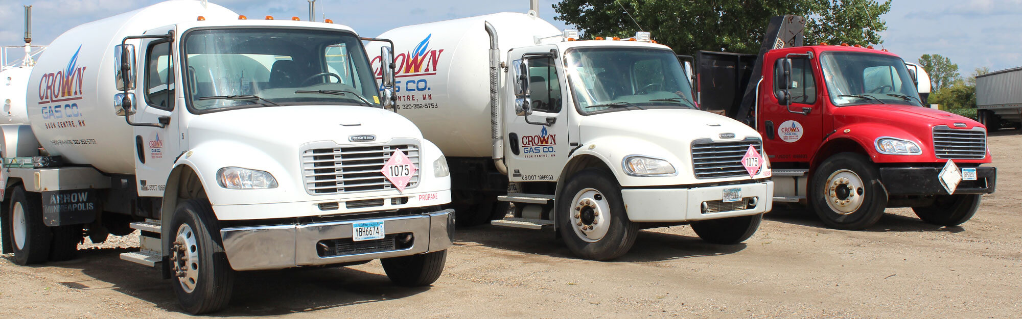Row of Crown Gas propane delivery and service trucks